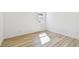 This bright bedroom has wood floors, white walls and trim, and a window providing ample natural light at 17245 Savory Mist Cir, Bradenton, FL 34211