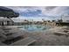 Large community pool with plenty of lounge chairs and tables surrounded by lush landscaping at 17245 Savory Mist Cir, Bradenton, FL 34211