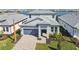 Beautiful two-story home with gray accents, well-manicured landscaping, and a paver driveway at 17245 Savory Mist Cir, Bradenton, FL 34211