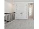 Upstairs hallway with carpet floors and view of stairway at 17245 Savory Mist Cir, Bradenton, FL 34211