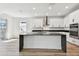 A kitchen with an island, stainless steel appliances, and white cabinets at 17245 Savory Mist Cir, Bradenton, FL 34211