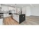 A modern kitchen with a large island, stainless steel appliances, and hardwood flooring at 17245 Savory Mist Cir, Bradenton, FL 34211