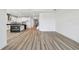 Open-concept living space with kitchen island, wood floors, and staircase at 17245 Savory Mist Cir, Bradenton, FL 34211