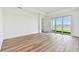 Bright living room with wood floors and large windows with views of the lake and community at 17245 Savory Mist Cir, Bradenton, FL 34211