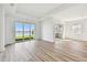 Bright living room with wood floors, large windows, and views of the lake and lawn at 17245 Savory Mist Cir, Bradenton, FL 34211