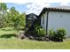A well manicured lawn and garden area are showcased in this backyard view at 2735 Lavandula Ct, North Port, FL 34289