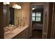 Bathroom featuring double sinks, walk-in shower and access to bedroom at 2735 Lavandula Ct, North Port, FL 34289
