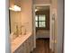 Bathroom featuring double sinks, walk-in shower and access to bedroom at 2735 Lavandula Ct, North Port, FL 34289