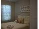 Cozy bedroom with neutral colors and a decorative curtain near the window at 2735 Lavandula Ct, North Port, FL 34289