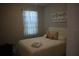 Cozy bedroom with neutral colors and a decorative curtain near the window at 2735 Lavandula Ct, North Port, FL 34289