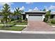 Beautiful single-story home with a brick driveway, well-maintained landscaping, and a two-car garage at 2735 Lavandula Ct, North Port, FL 34289