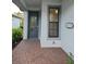 Inviting front entrance with a decorative door, sidelight window, and brick-paved porch at 2735 Lavandula Ct, North Port, FL 34289