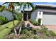 Charming home featuring lush landscaping, decorative plants, and a brick pathway leading to the entrance at 2735 Lavandula Ct, North Port, FL 34289