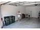 Spacious garage with white walls, concrete floor and a Personal walking across at 2735 Lavandula Ct, North Port, FL 34289