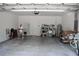 Spacious garage featuring white walls, concrete floor, water heater, utility sink and storage shelves at 2735 Lavandula Ct, North Port, FL 34289