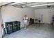 Spacious garage with white walls, concrete floor and a Personal walking across at 2735 Lavandula Ct, North Port, FL 34289