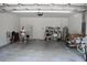 Spacious garage featuring white walls, concrete floor, water heater, utility sink and storage shelves at 2735 Lavandula Ct, North Port, FL 34289