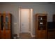 Hallway leading to bedroom with beautiful wood floors, cabinets, and neutral paint color at 2735 Lavandula Ct, North Port, FL 34289