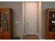 Hallway with wood-look tile flooring, neutral paint, and access to other rooms, including the laundry room at 2735 Lavandula Ct, North Port, FL 34289