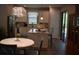 Modern kitchen with white cabinets, stainless steel appliances, a center island, and stylish pendant lighting at 2735 Lavandula Ct, North Port, FL 34289