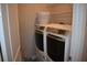 Practical laundry room with shelving and modern washer and dryer units at 2735 Lavandula Ct, North Port, FL 34289