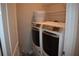 Practical laundry room with shelving and modern washer and dryer units at 2735 Lavandula Ct, North Port, FL 34289