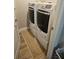 Modern laundry room featuring a washer and dryer with stylish flooring at 2735 Lavandula Ct, North Port, FL 34289
