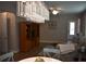 An inviting living room with a striking chandelier, wood floors, and comfortable furnishings at 2735 Lavandula Ct, North Port, FL 34289