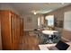 Open-concept living area with wood-look flooring, dining table, and ample natural light from the window at 2735 Lavandula Ct, North Port, FL 34289