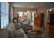 Comfortable living room with a sectional sofa, round coffee table, and an open view into the kitchen at 2735 Lavandula Ct, North Port, FL 34289