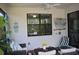 Charming covered patio with comfortable wicker seating, nautical décor, and ceiling fan at 2735 Lavandula Ct, North Port, FL 34289