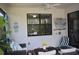 Charming covered patio area with brick flooring, ceiling fan, and comfortable wicker seating arrangement at 2735 Lavandula Ct, North Port, FL 34289