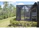Relaxing screened patio with view of landscaping, beautiful trees and partial view of house at 2735 Lavandula Ct, North Port, FL 34289