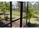 Screened in patio with lush green backyard, view of trees and beautiful landscaping at 2735 Lavandula Ct, North Port, FL 34289