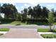 A quiet street view with mature trees and manicured hedges adding to the neighborhood's appeal at 2735 Lavandula Ct, North Port, FL 34289