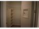 Walk-in closet with extensive shelving and a decorative wall niche at 2735 Lavandula Ct, North Port, FL 34289