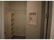 Walk-in closet with extensive shelving and a decorative wall niche at 2735 Lavandula Ct, North Port, FL 34289