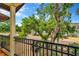 Balcony view features mature trees, landscaping and an ornate metal railing overlooking the street at 4604 W Fig St # 1, Tampa, FL 33609