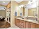Bathroom features double sinks with granite countertops, a large mirror, and access to the bedroom at 4604 W Fig St # 1, Tampa, FL 33609