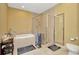 Well-maintained bathroom featuring a glass-enclosed shower and a soaking tub at 4604 W Fig St # 1, Tampa, FL 33609