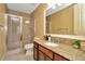 Bathroom featuring a glass enclosed shower, granite vanity and neutral tile floors at 4604 W Fig St # 1, Tampa, FL 33609