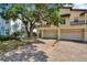 Stunning exterior view of home with mature landscaping and a multi-car garage and brick paved driveway at 4604 W Fig St # 1, Tampa, FL 33609