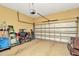 A two car garage with speckled flooring, overhead door hardware and storage at 4604 W Fig St # 1, Tampa, FL 33609