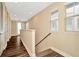 Hallway with neutral walls, decorative wood-look flooring, and natural light from several windows at 4604 W Fig St # 1, Tampa, FL 33609