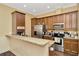 Well-equipped kitchen featuring wood cabinets, stainless steel appliances, granite countertops and convenient coffee bar at 4604 W Fig St # 1, Tampa, FL 33609