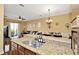 Open-concept kitchen offers a breakfast bar, stainless steel sink, and views of the living and dining areas at 4604 W Fig St # 1, Tampa, FL 33609
