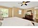 Bedroom features a dresser with a mirror, windows, and wood floors at 4604 W Fig St # 1, Tampa, FL 33609