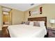 Inviting main bedroom with wood floors, a comfortable bed, and an ensuite bathroom at 4604 W Fig St # 1, Tampa, FL 33609