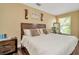 Comfortable bedroom featuring a bed, natural light from a large window, and wood flooring at 4604 W Fig St # 1, Tampa, FL 33609