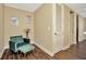 Cozy sitting area featuring an accent chair and foot stool with modern decor and wood-look flooring at 4604 W Fig St # 1, Tampa, FL 33609